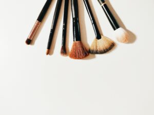 A set of makeup brushes arranged on a white surface, perfect for beauty and cosmetic themes.